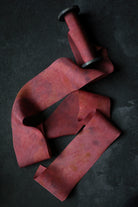 red ribbon on wood spool