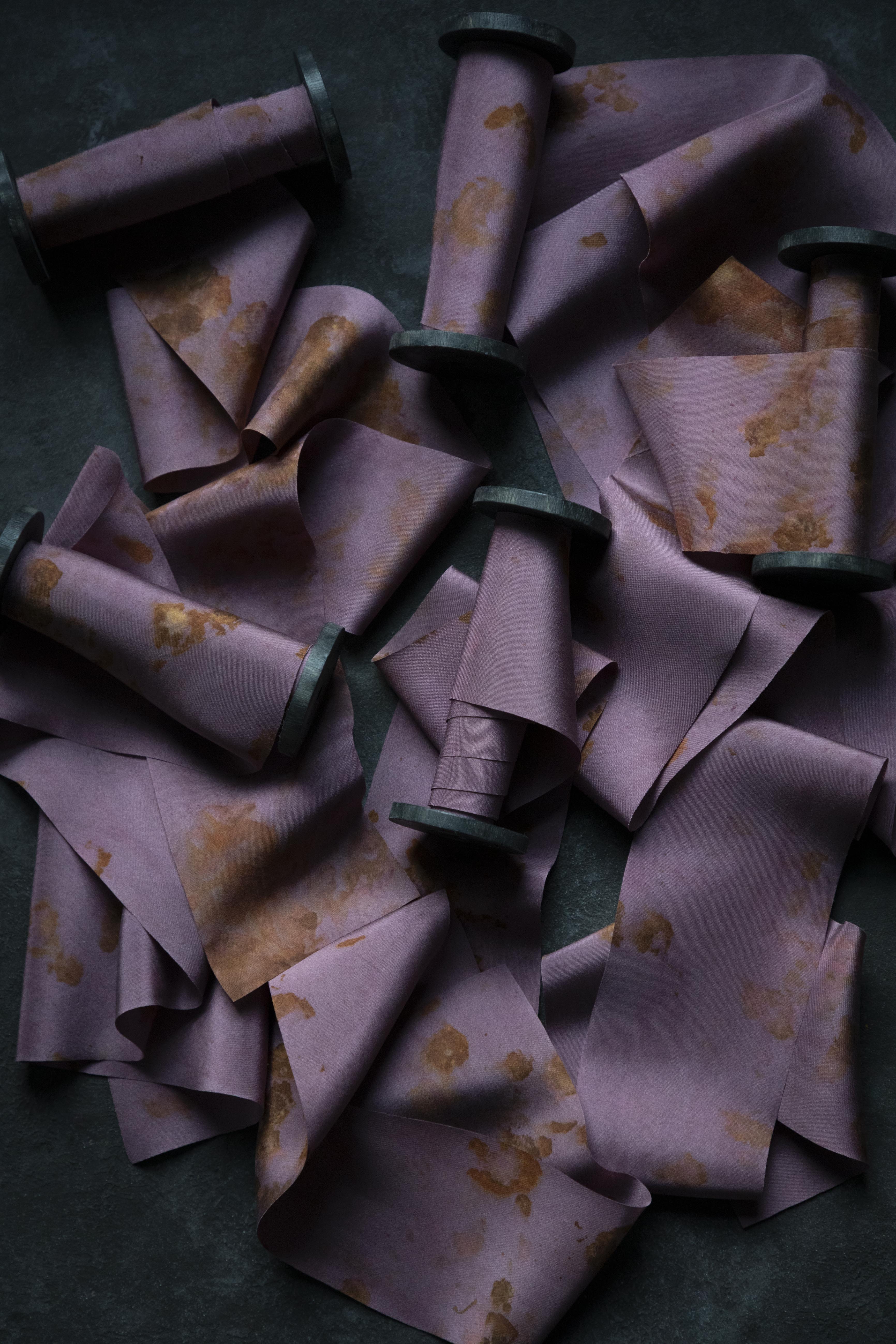 Purple fabric cones with floral patterns on a dark surface