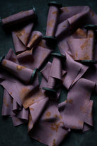 Purple fabric cones with floral patterns on a dark surface
