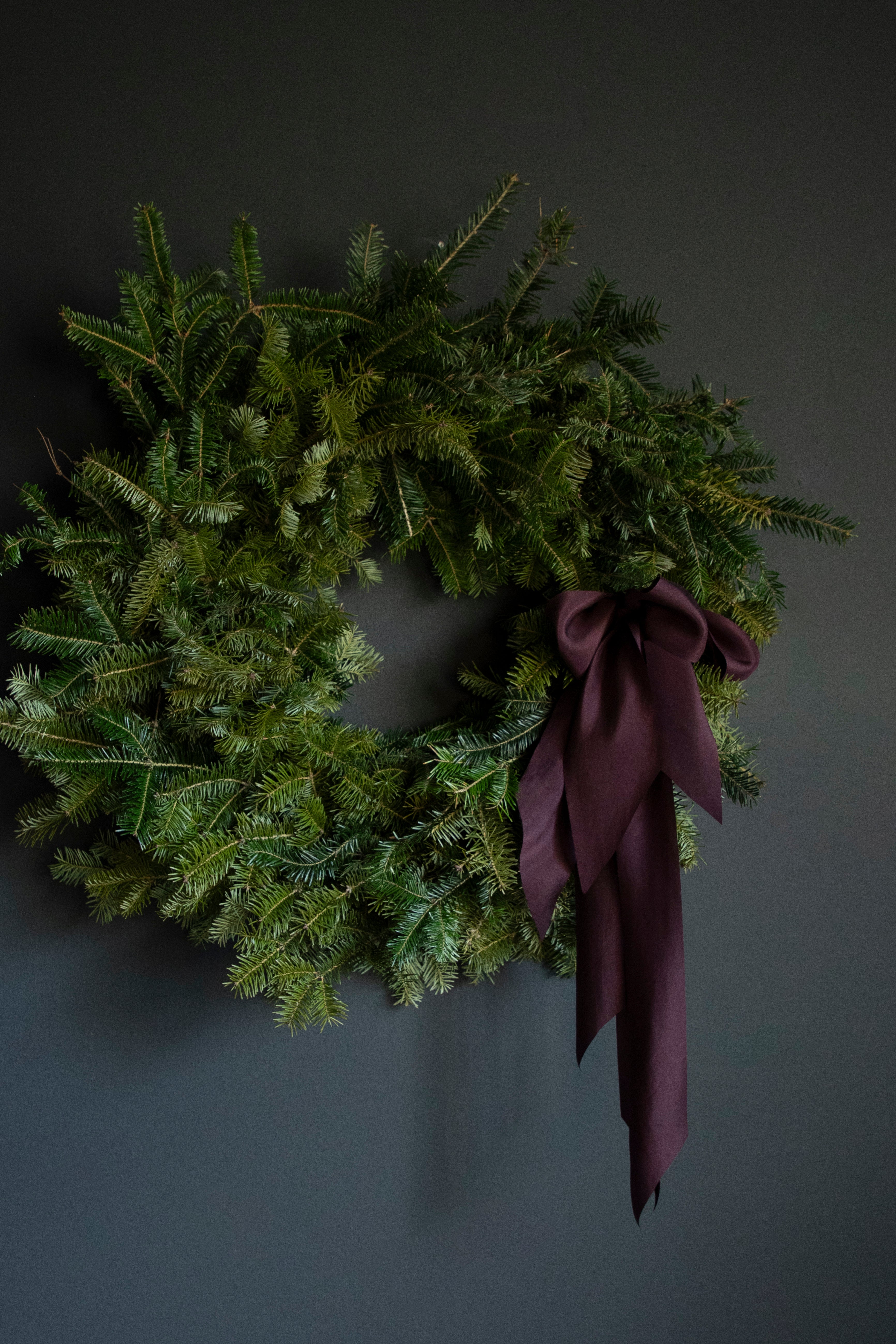 modern wreath design with plant dyed silk ribbons
