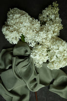White flowers on a dark background with green fabric