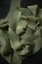 Folded light green fabric on a dark background