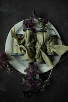 premium green ribbons set on a white ceramic plate with decorative flowers