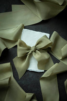 Large green bow on a dark surface