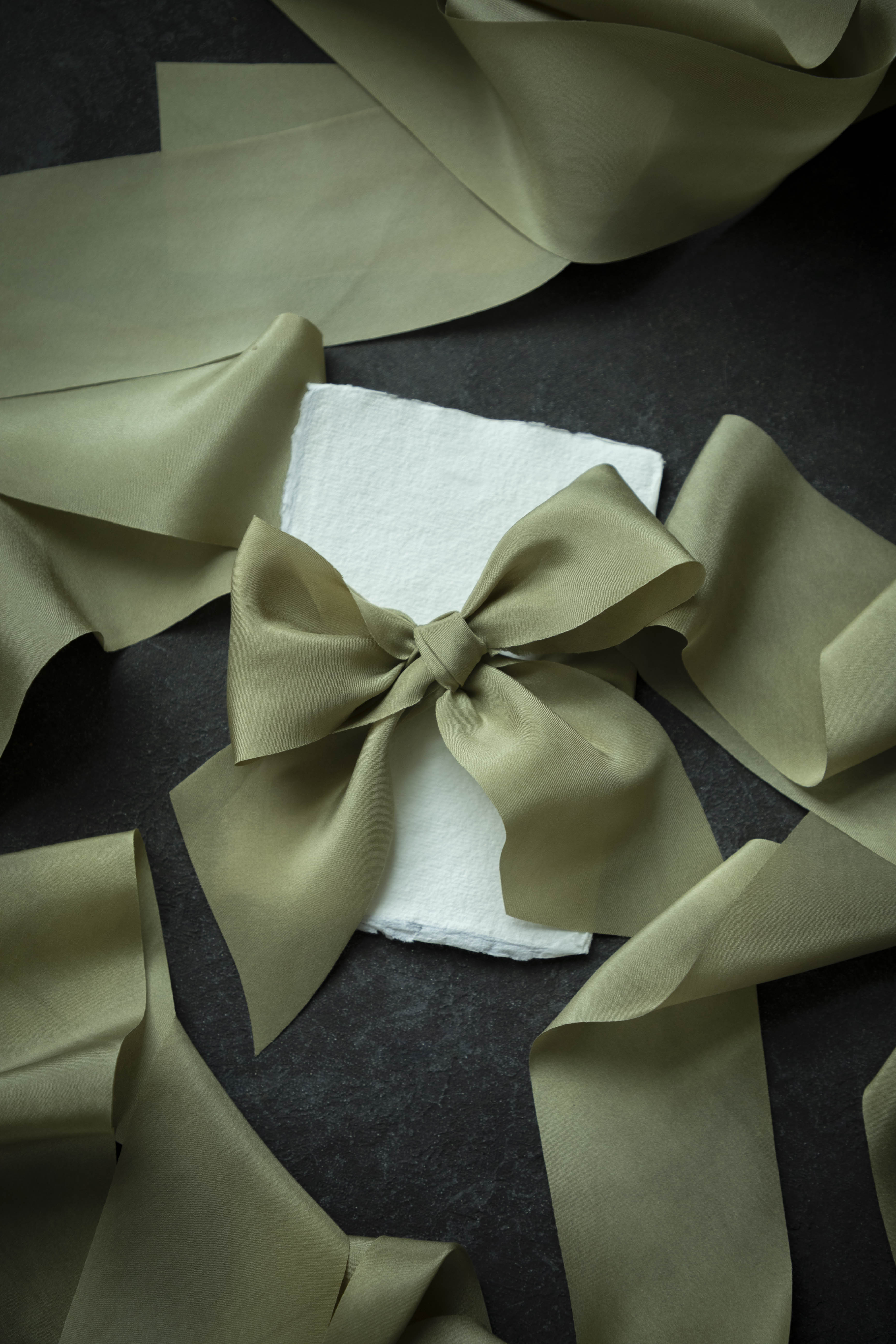 Large green bow on a dark surface