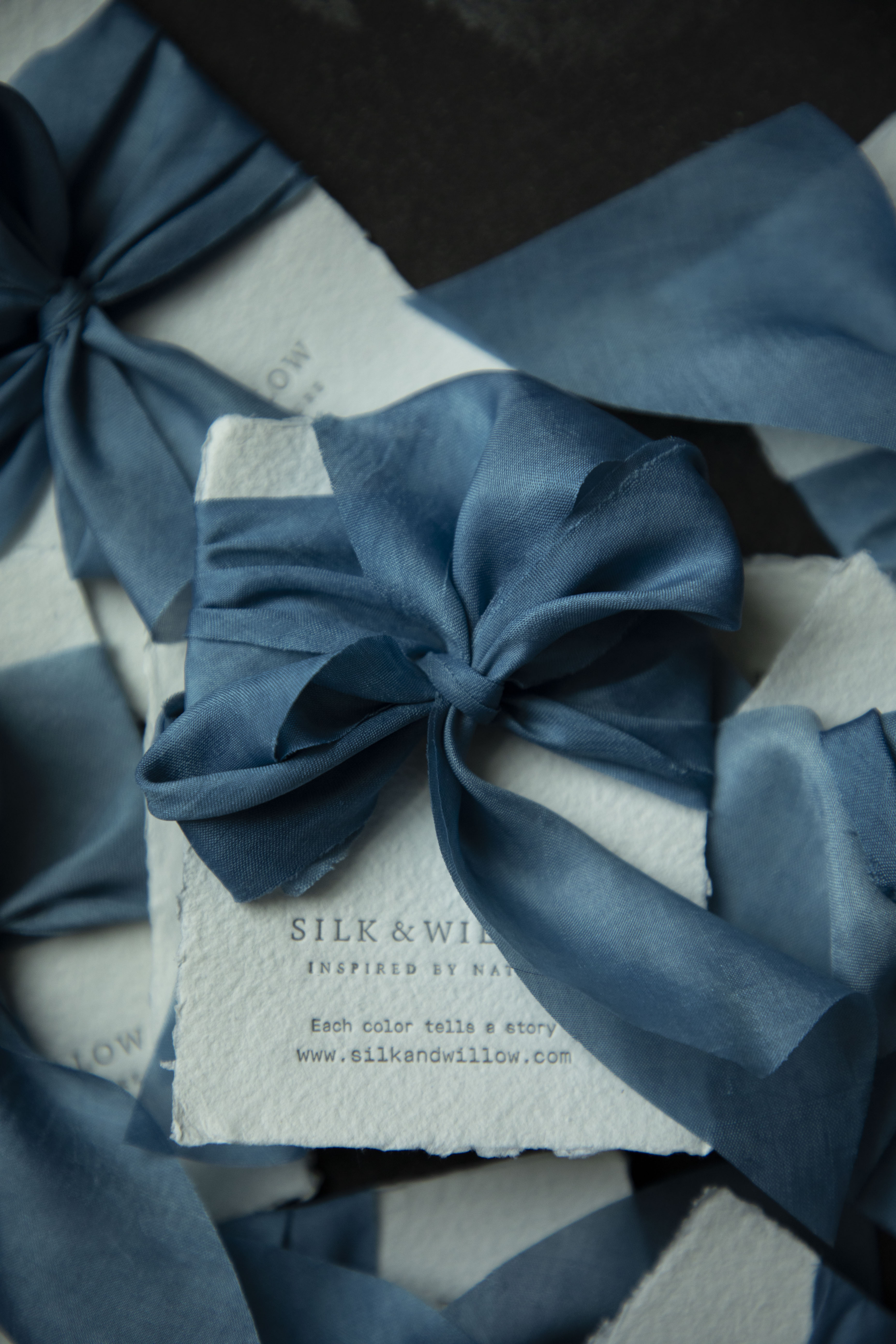 Indigo dyed Blue ribbon bow on a white box with 'Silk & Willow' branding.