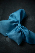 indigo dyed Blue ribbon bow on a dark surface