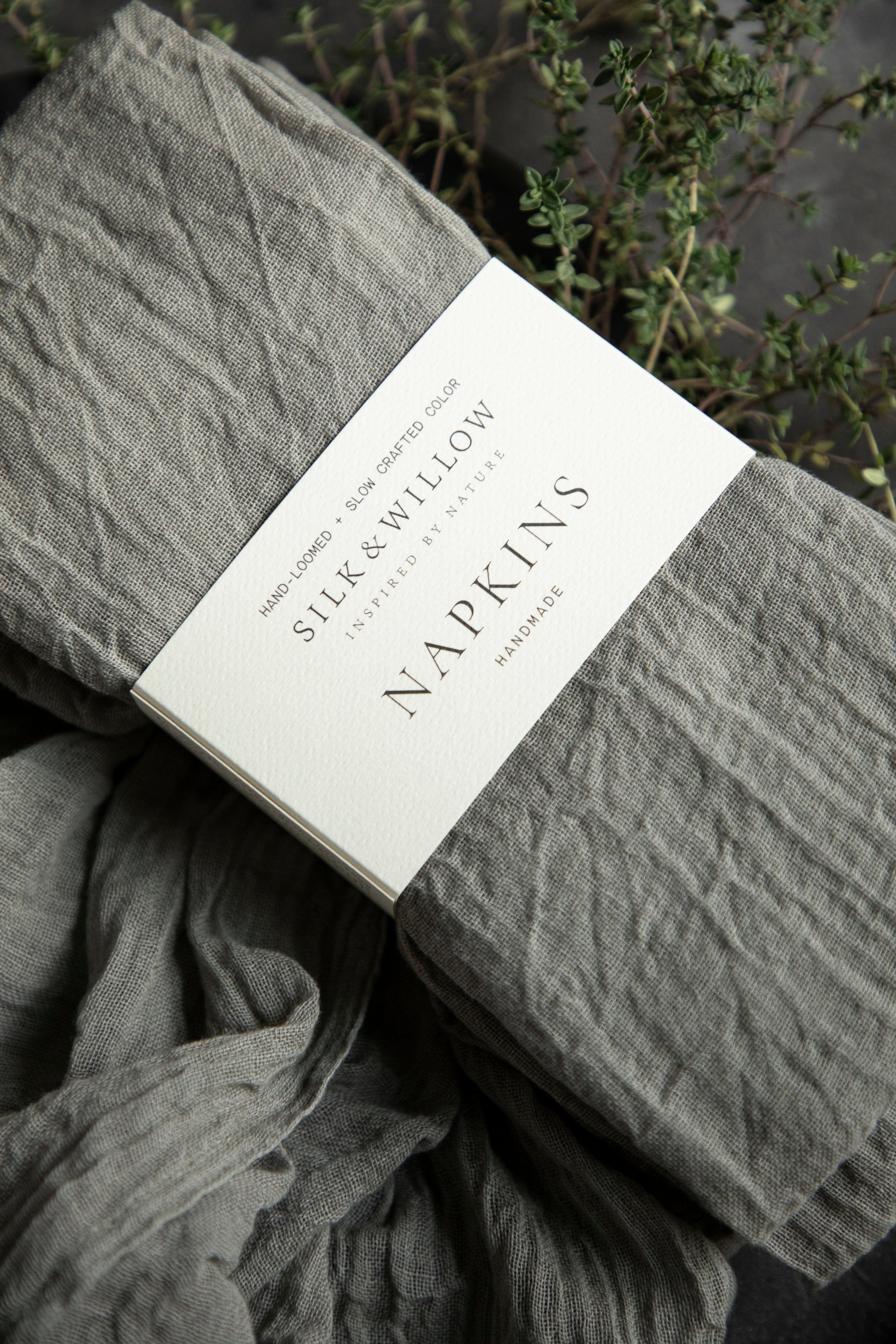 Gray napkins with a label on a dark background