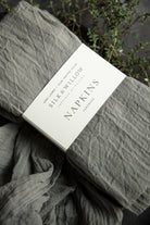Gray napkins with a label on a dark background