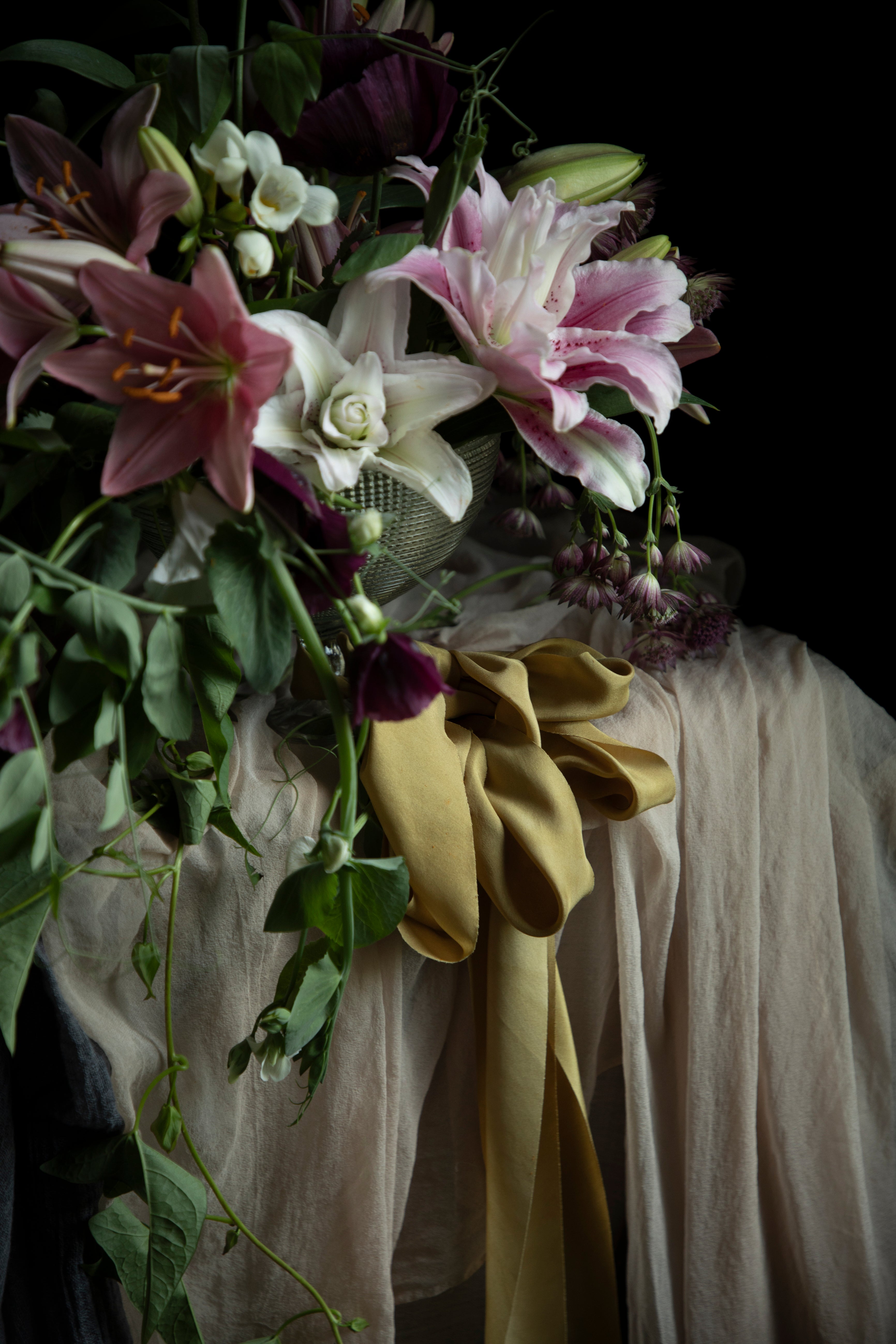 Bouquet of flowers with a yellow ribbon on a dark background
