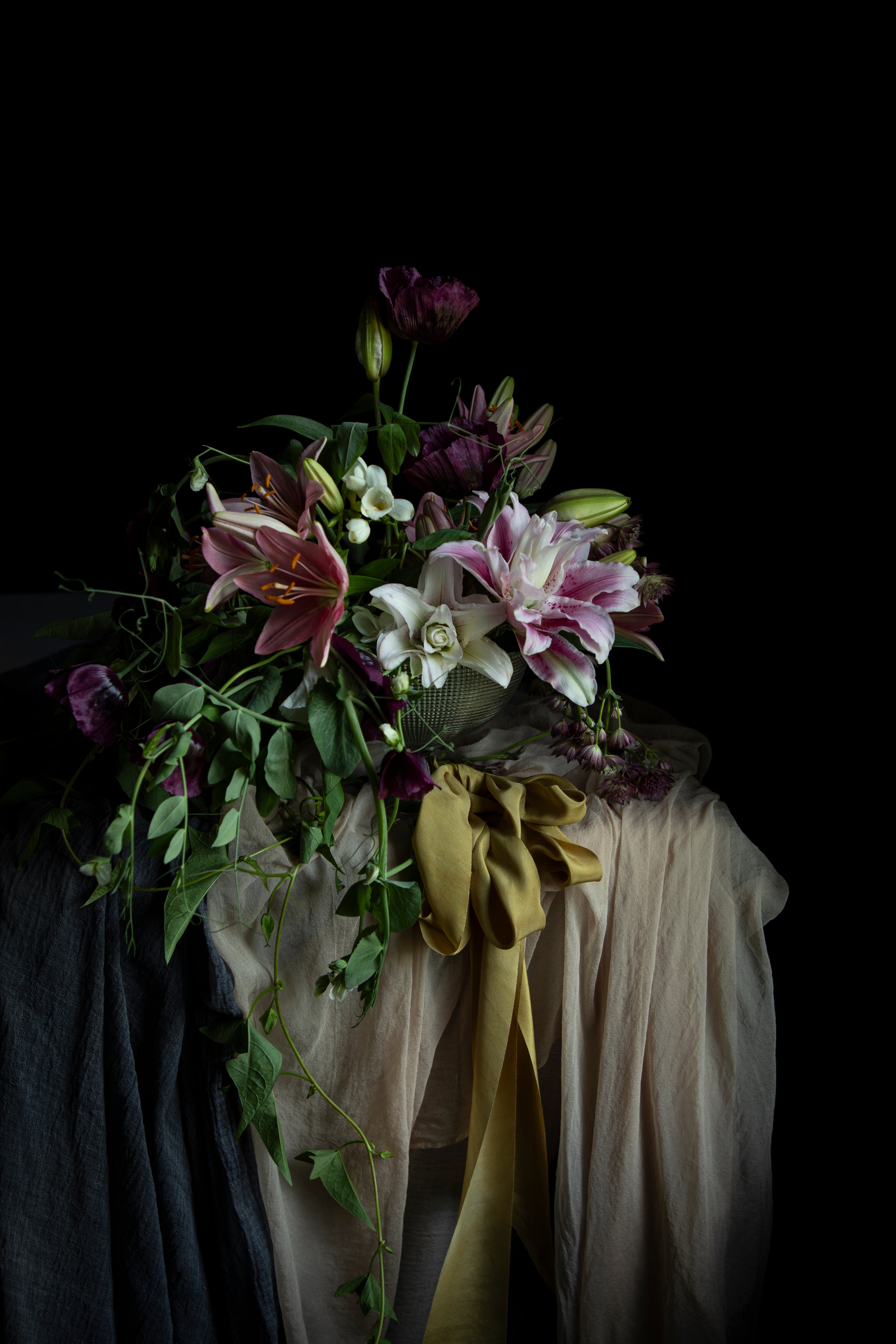 Floral arrangement with a yellow ribbon on a dark background