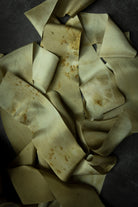 eco-print silk ribbons on dark background