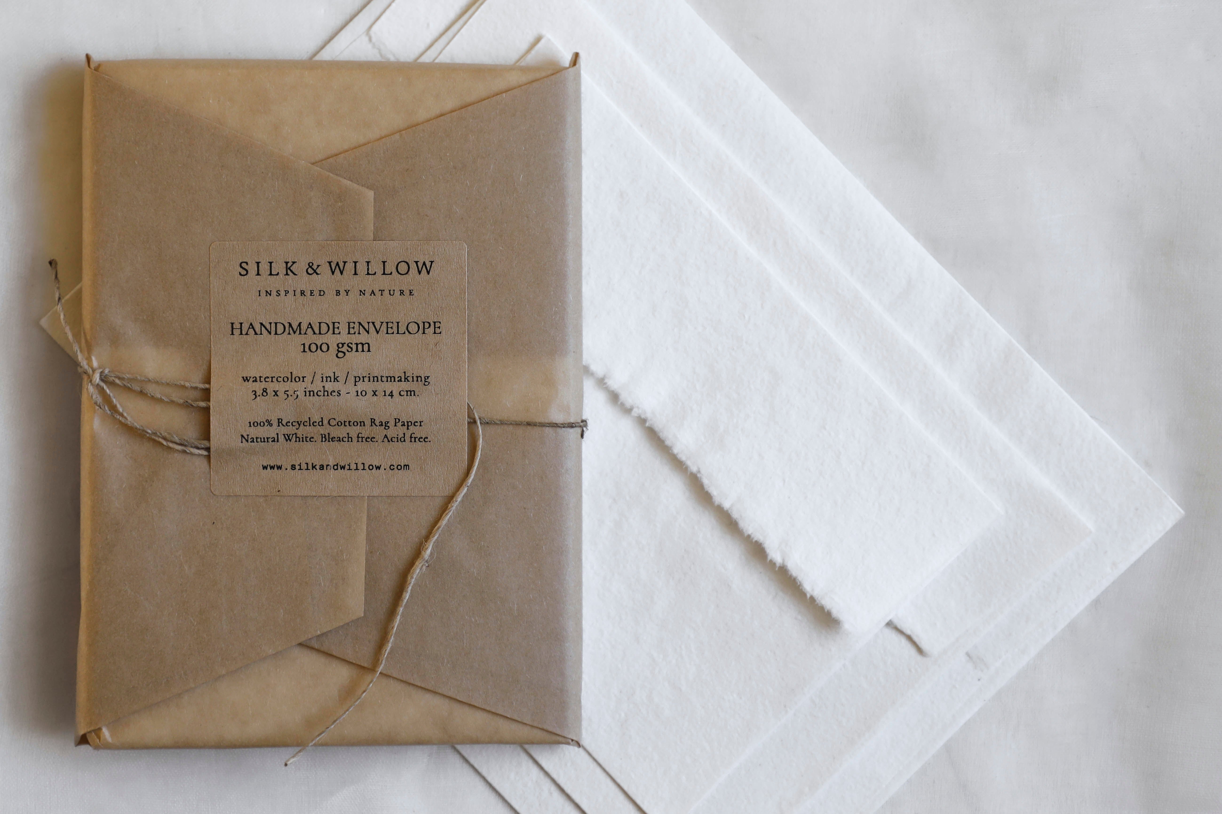 Handmade envelope with a label on a light wooden surface