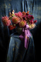 dahlia floral centerpiece tied with silk ribbon bow. Eco-friendly silk ribbons with nature-inspired patterns, perfect for unique gift wrapping and tying market bouquets, crafted from sustainable materials