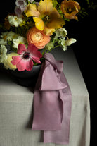 closeup of modern floral design for weddings. Purple silk ribbon accent