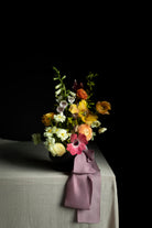 wedding flower arrangement with purple silk ribbon display