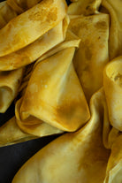 Close-up of yellow fabric with visible stains and discoloration