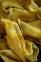 Yellow fabric with brown stains and discolorations