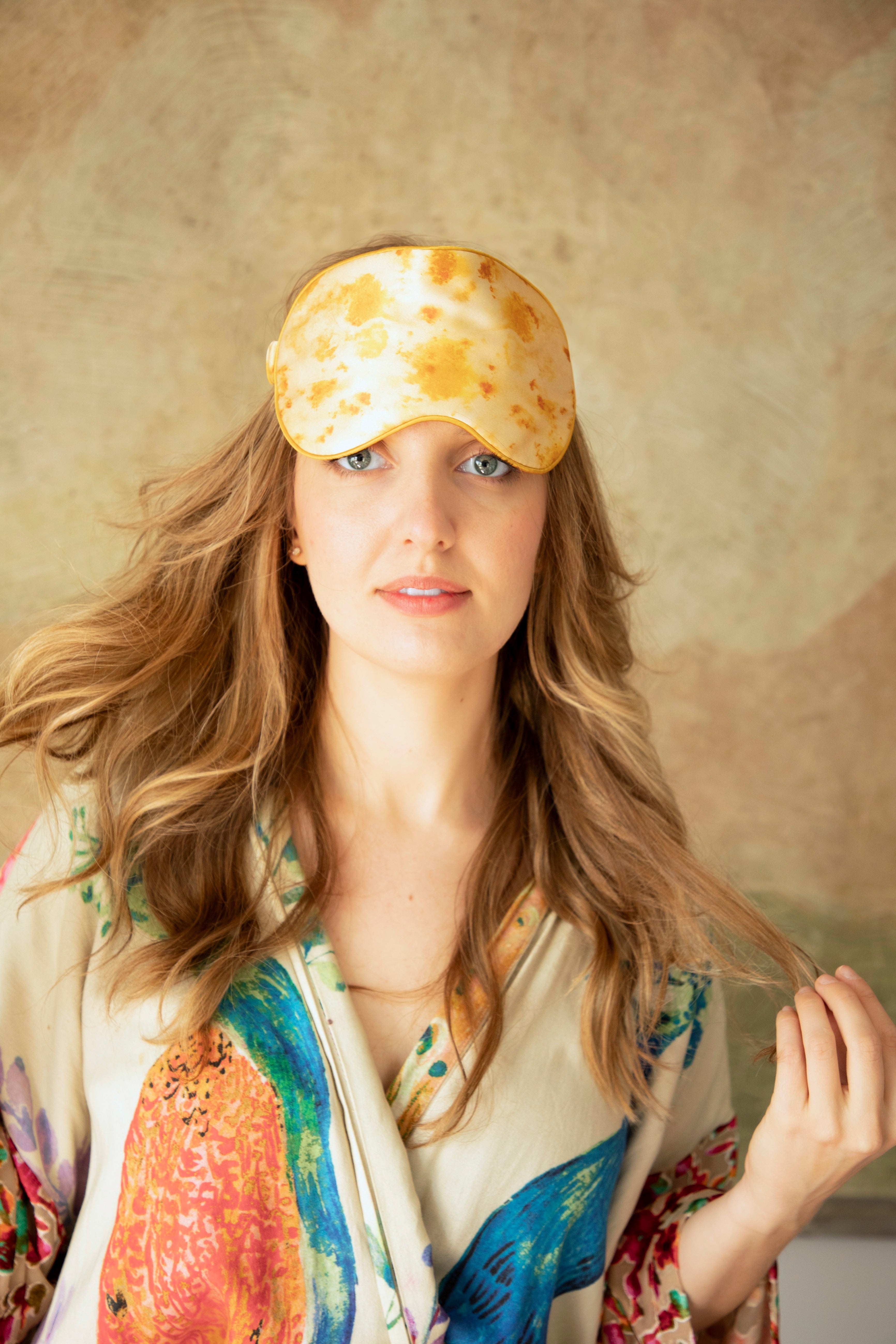 woman with long flowing hair wearing an anthropologie silk robe and a botanical print silk & Willow silk sleep eye mask