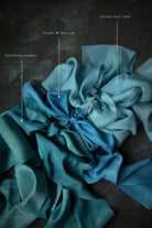 indigo dyed Blue ribbon swatches arranged on a dark background