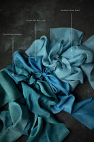 Blue palette od silk ribbon swatches arranged in a pattern on a dark background