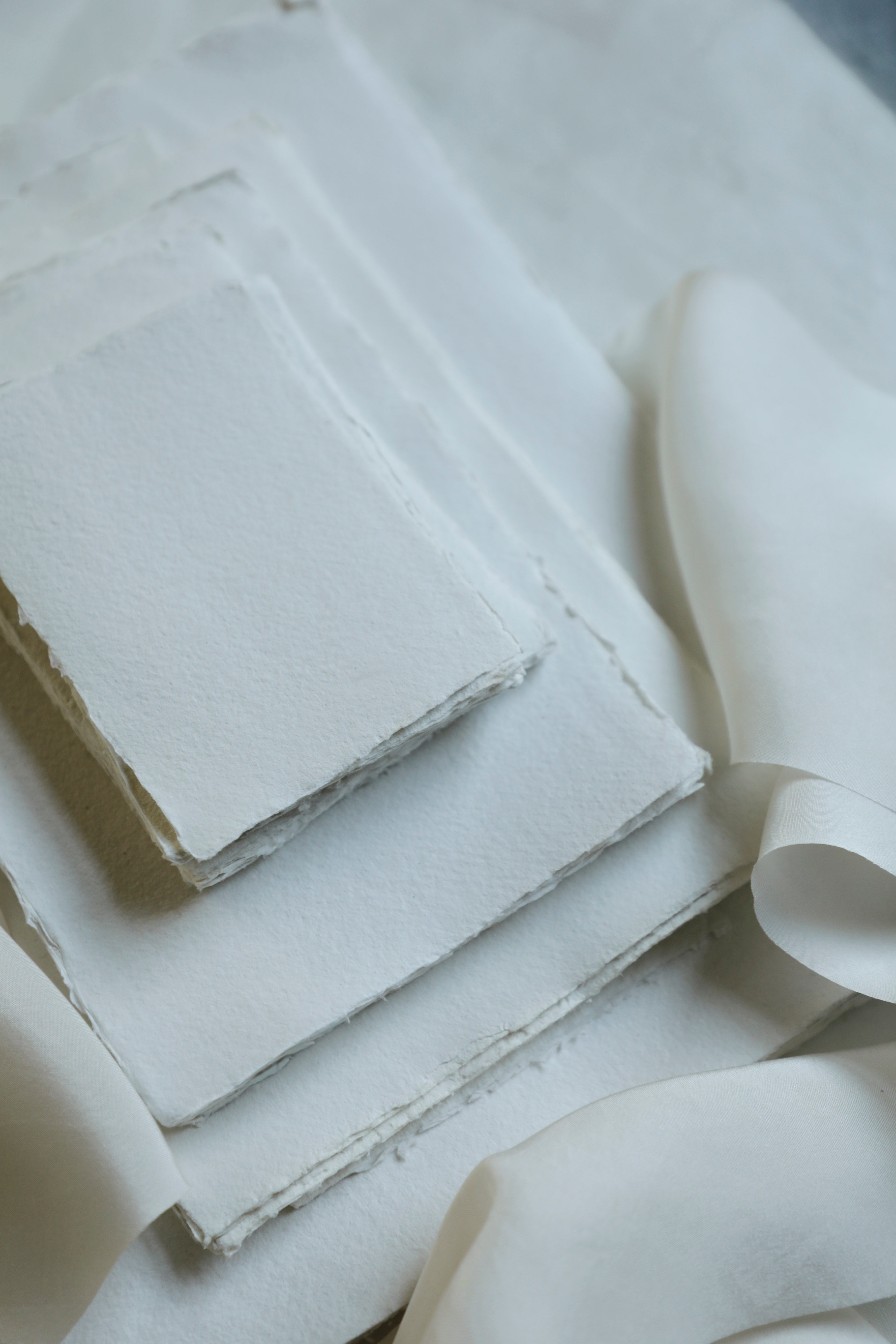 Stack of white paper sheets with a textured surface