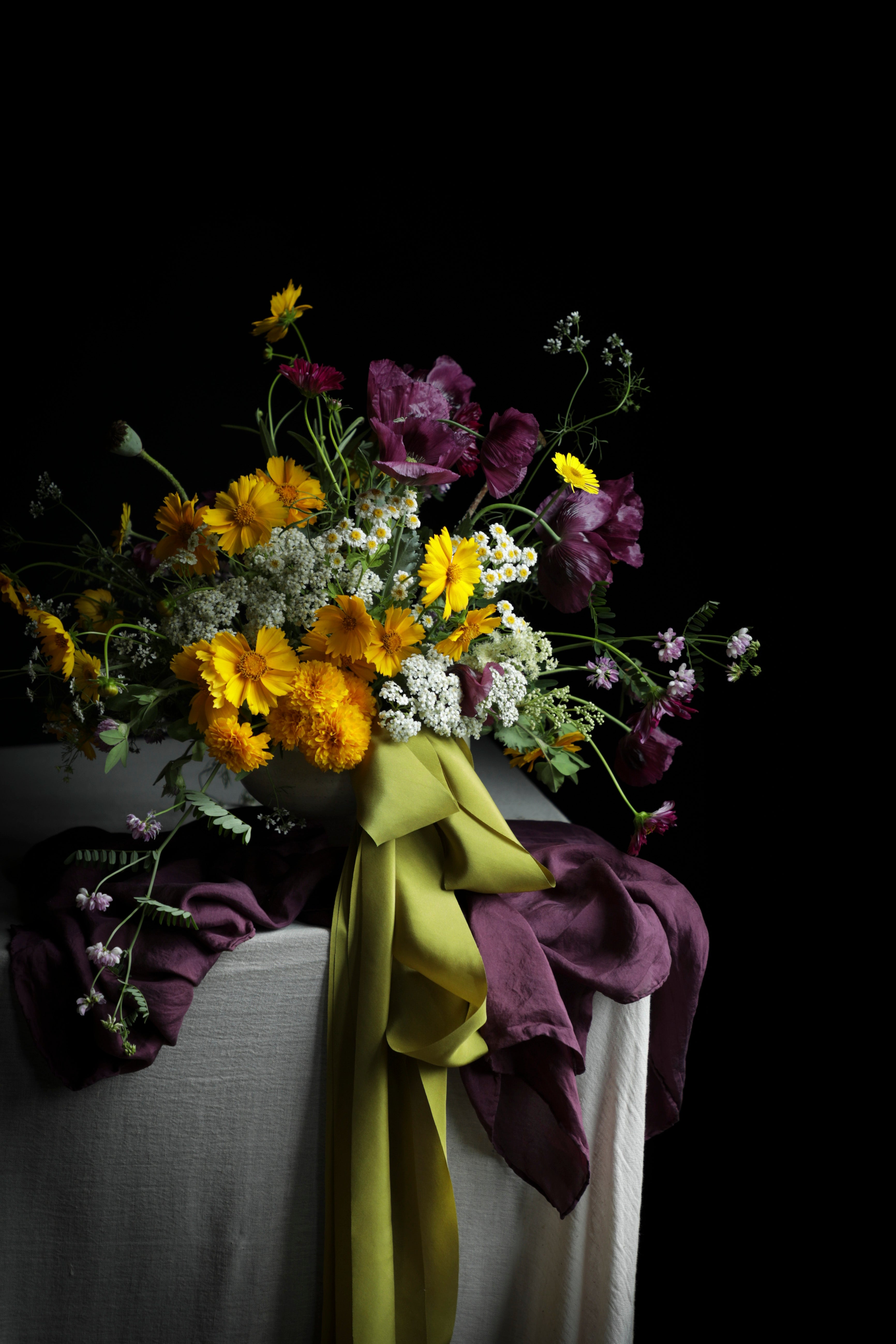 Bouquet of flowers with a green ribbon on a dark background
