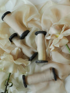 Spools of ombre ribbon on a fabric background