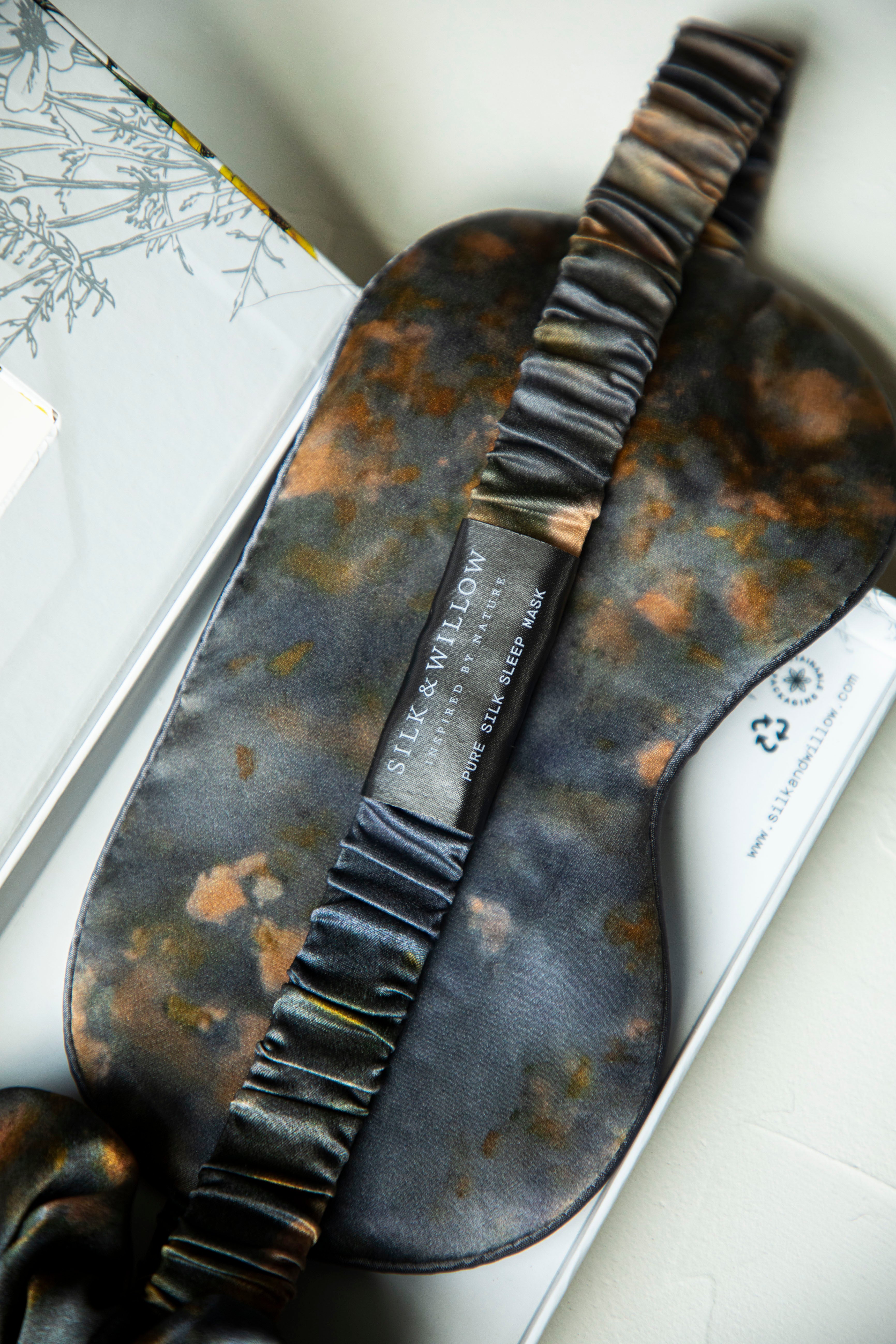 close-up of silk sleep eye mask with silk and willow branding.