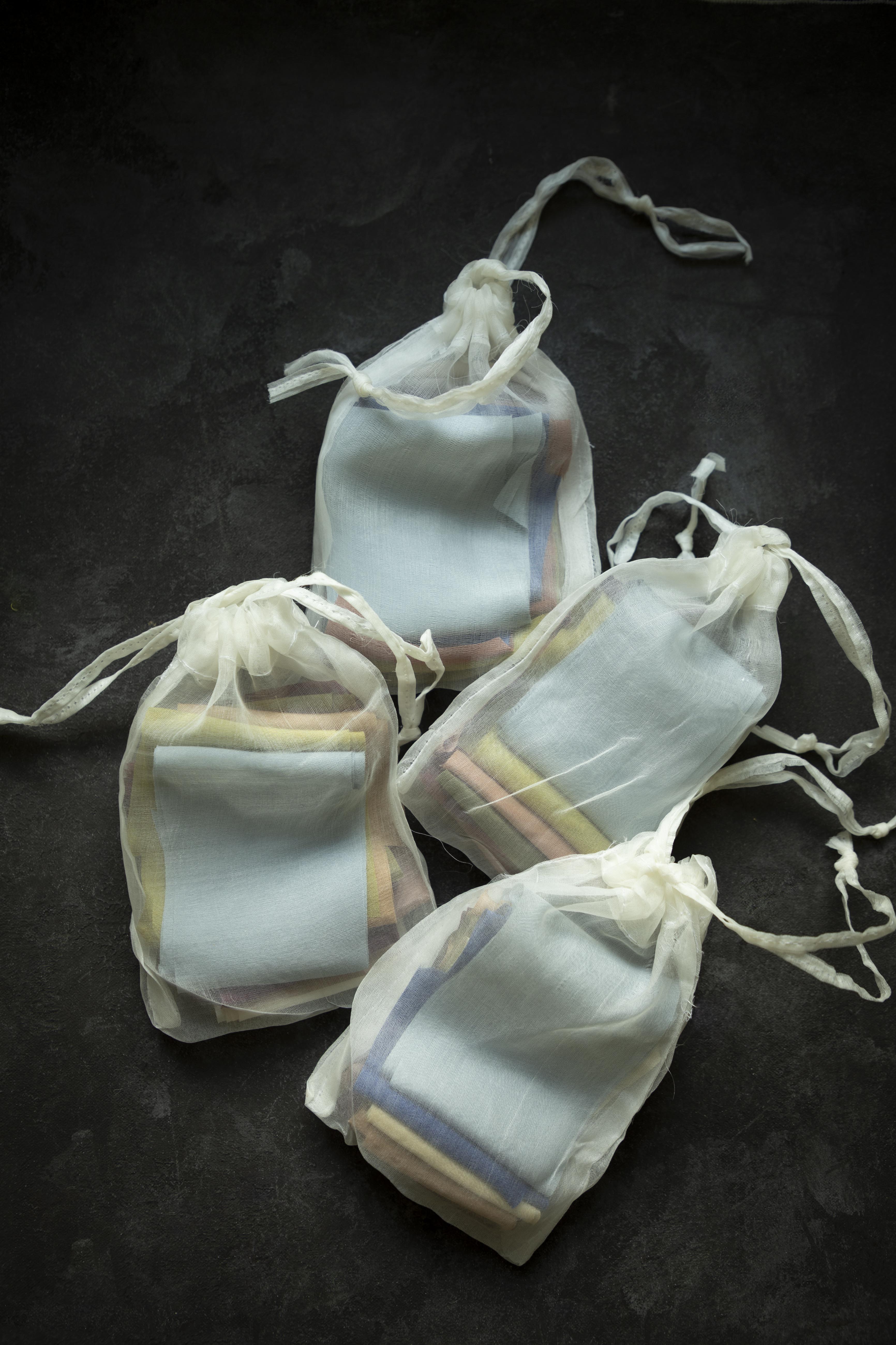 silk ribbons in a silk bag on black background