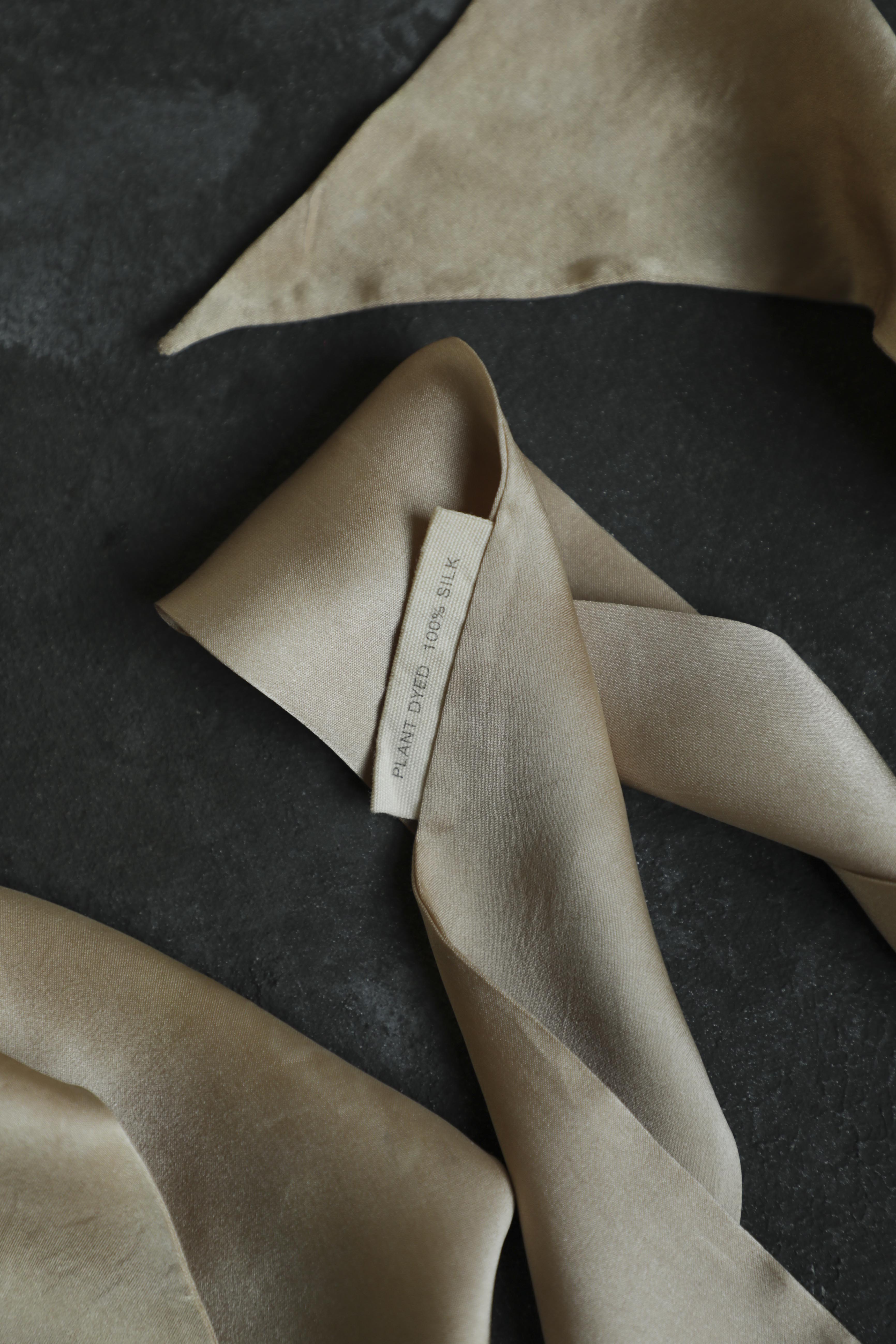 Beige fabric with a tag on a dark surface