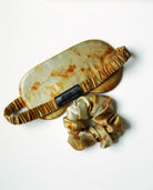 Set of eye mask and scrunchie with a natural pattern on a white background