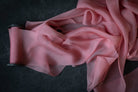 Pink silk ribbon fabric on a dark background