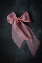 Pink bow on a dark textured background
