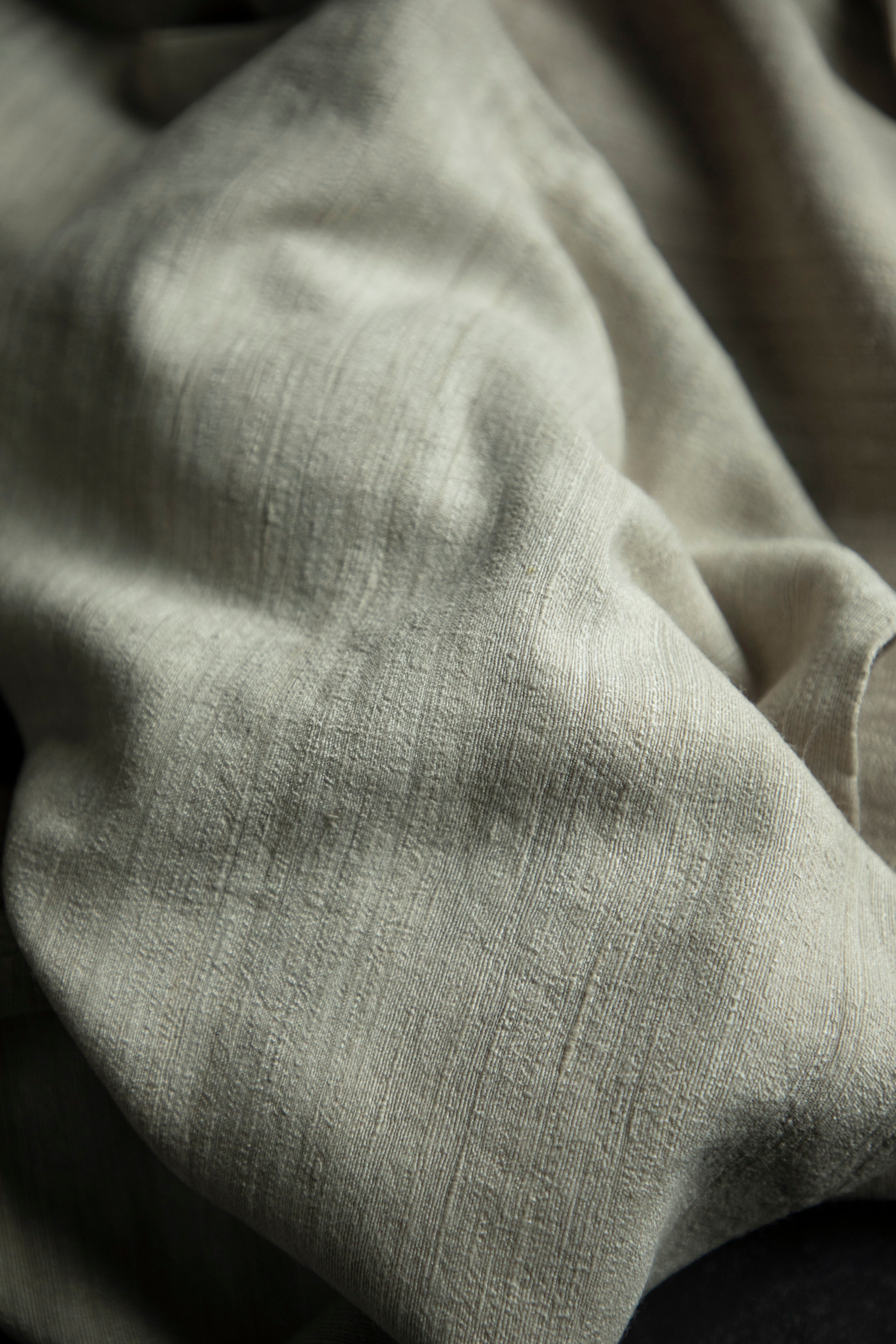 Close-up of textured gray fabric with folds