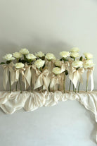 unique wedding decor. white rose stems with silk ribbons