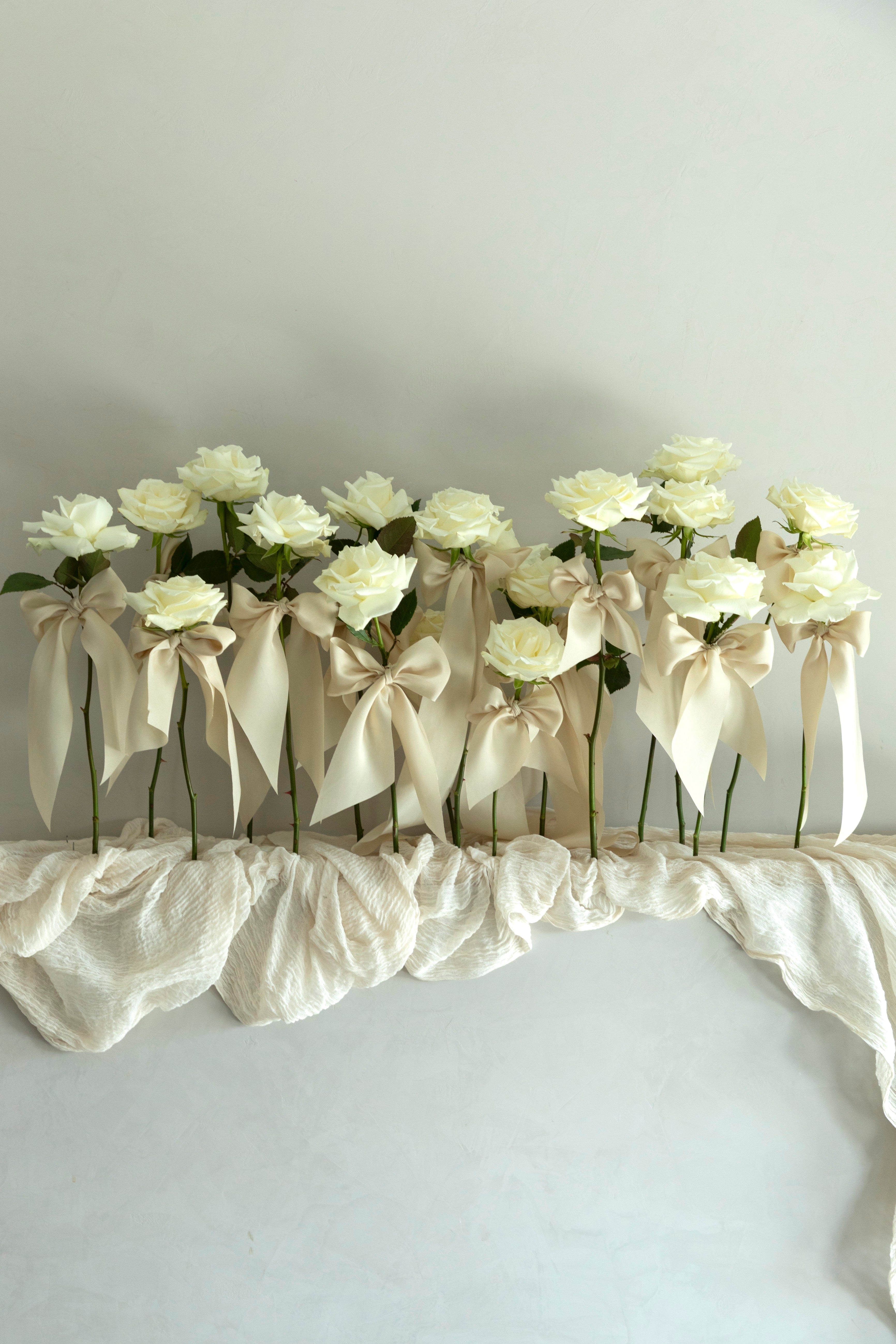 unique wedding decor. white rose stems with silk ribbons