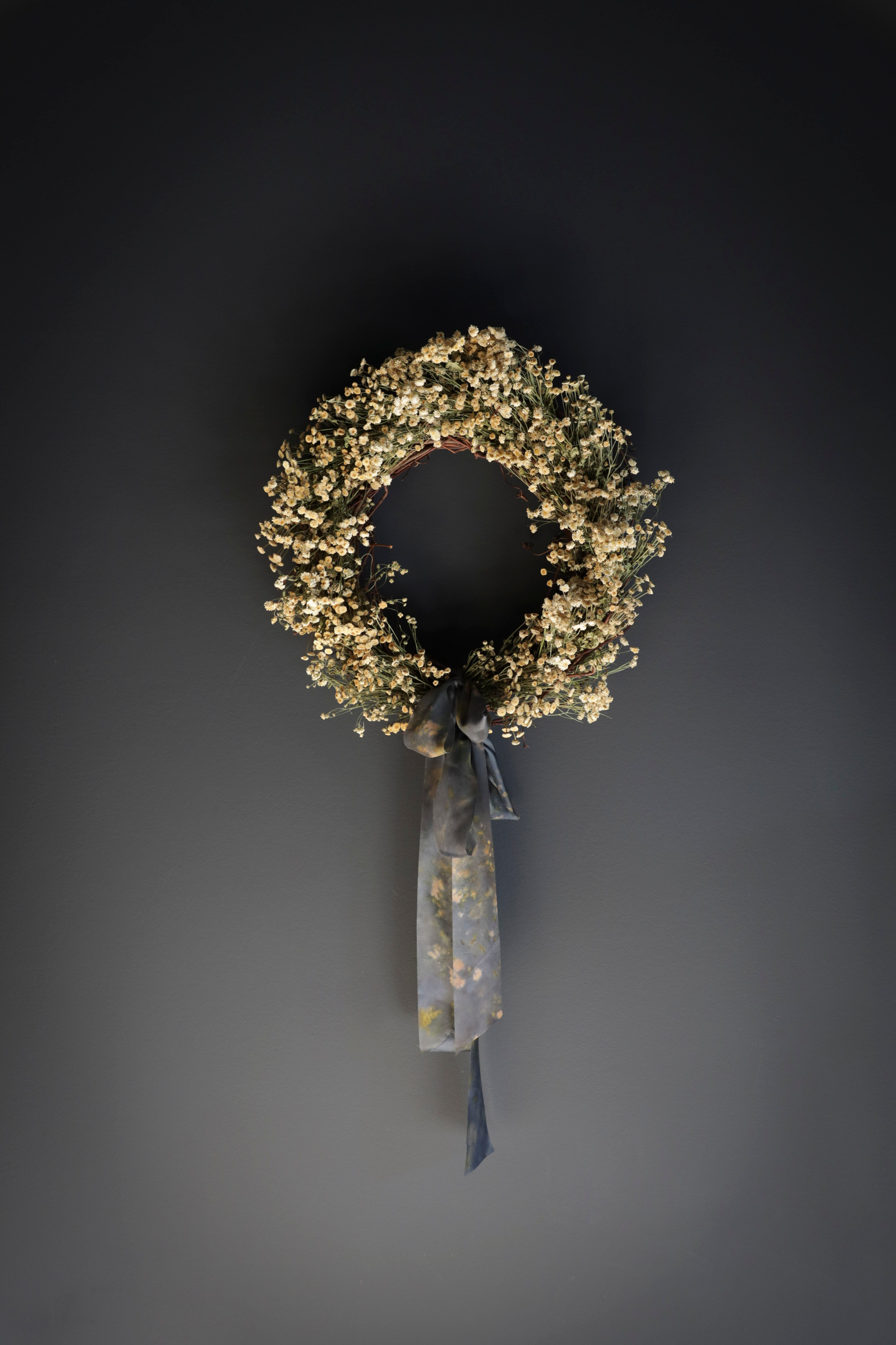 dried wreath tied with silk ribbon bow. Eco-friendly silk ribbons with nature-inspired patterns, perfect for unique gift wrapping and tying market bouquets, crafted from sustainable materials