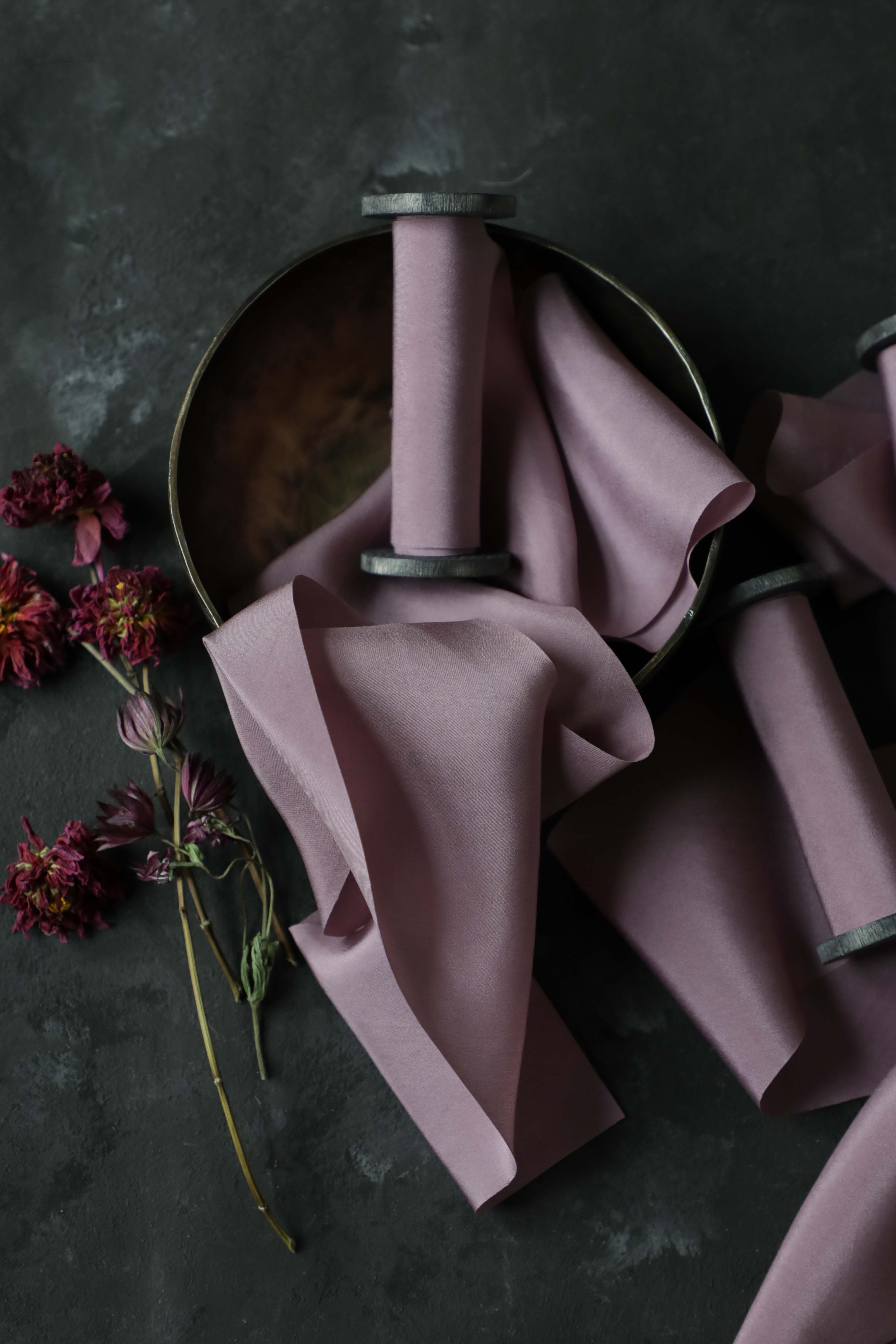 lilac silk ribbon in a bowl against a black background