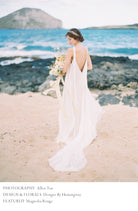 coastal elopement with bride holding a bridal bouquet with flowing silk ribbon. Featured on Magnolia Rouge Wedding blog.