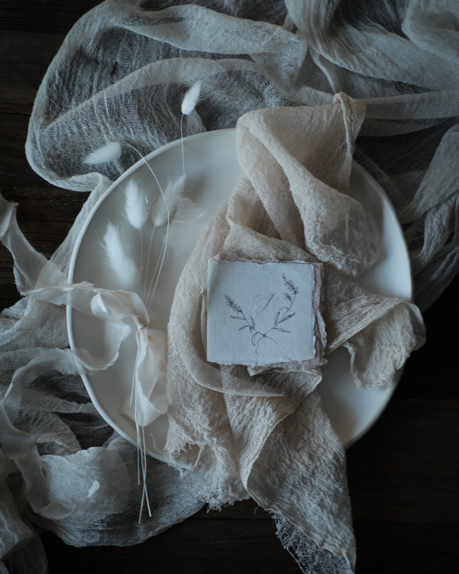silk and willow table setting design with blush napkin, antique white table runner and white ceramic plates