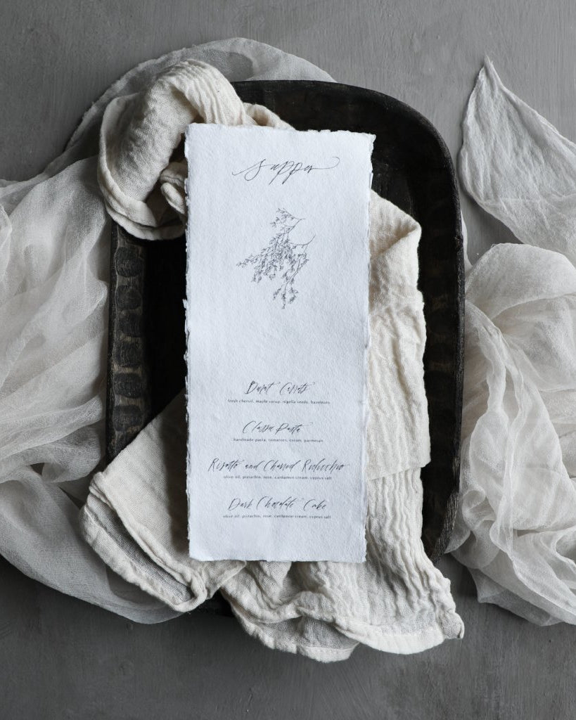 custom menu design displayed on a silk and willow cotton antique white napkin