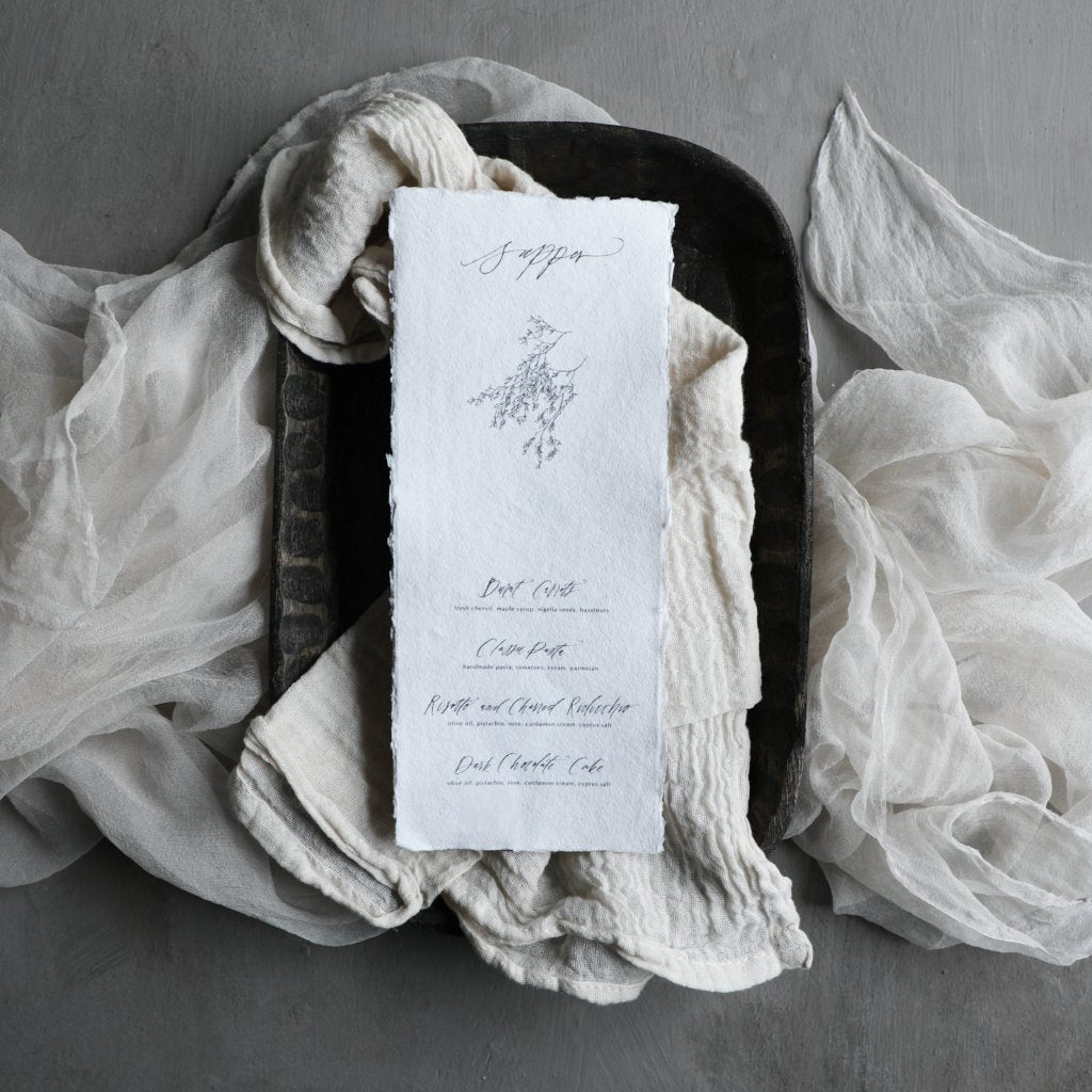 custom menu design displayed on a silk and willow cotton antique white napkin