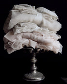 antique white sheer silk and blush sheer silk displayed on an antique silver tray