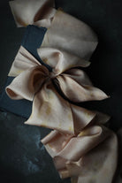 handmade paper for custom wedding invitations with plant dyed silk ribbon