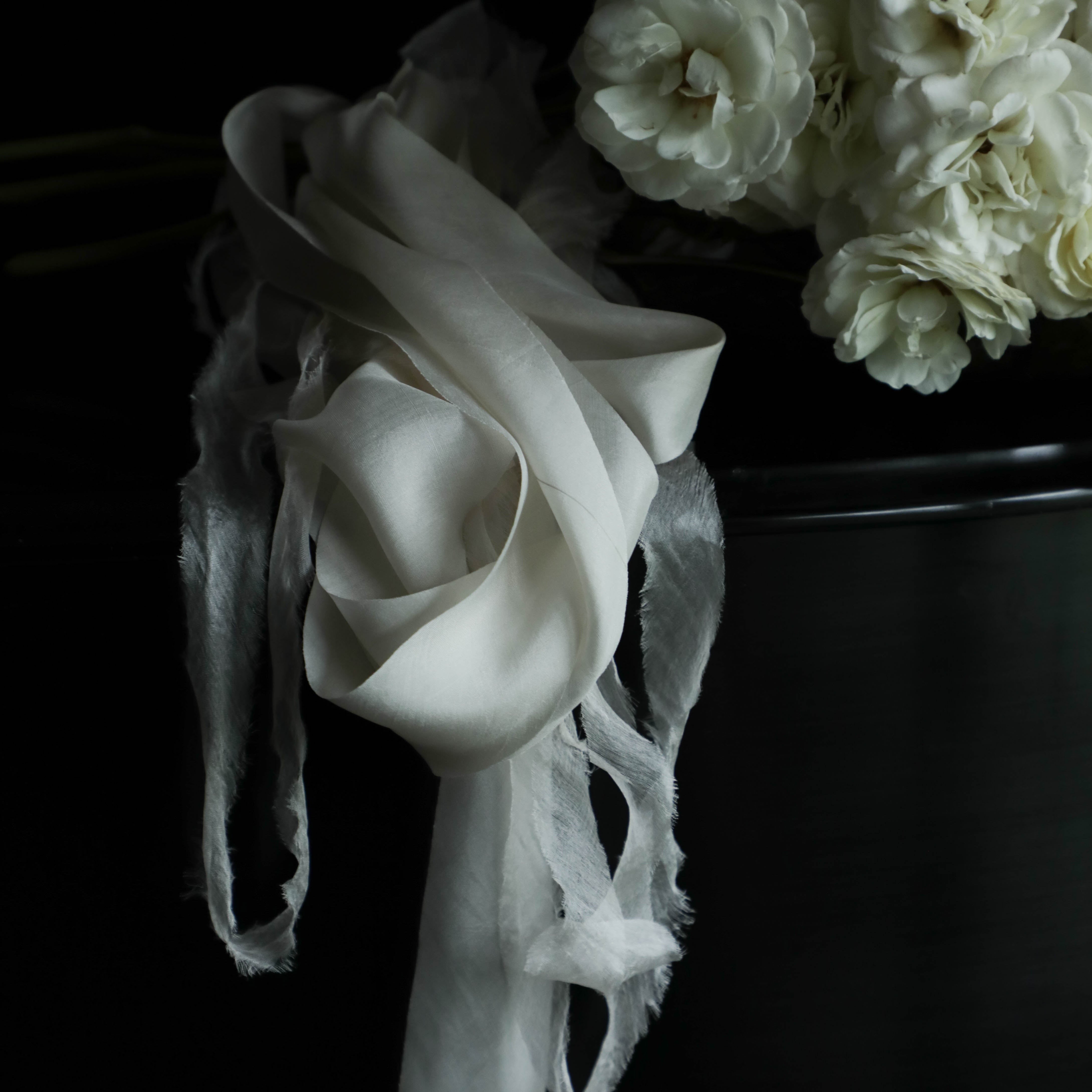 white roses with white organic silk ribbon on a steinway paino