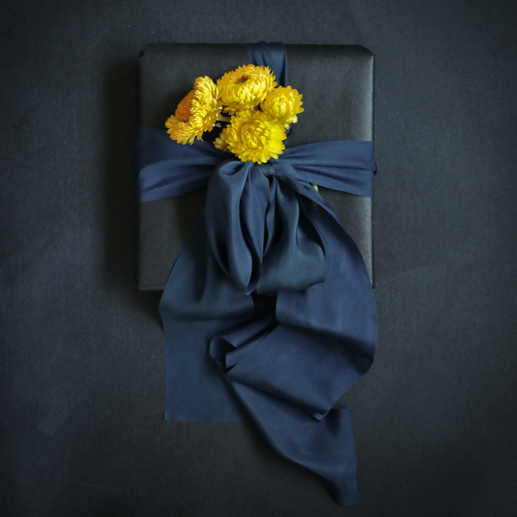 gift wrapping with dried flowers. sapphire blue silk ribbon
