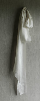 antique white silk ribbon on a linen pin board 