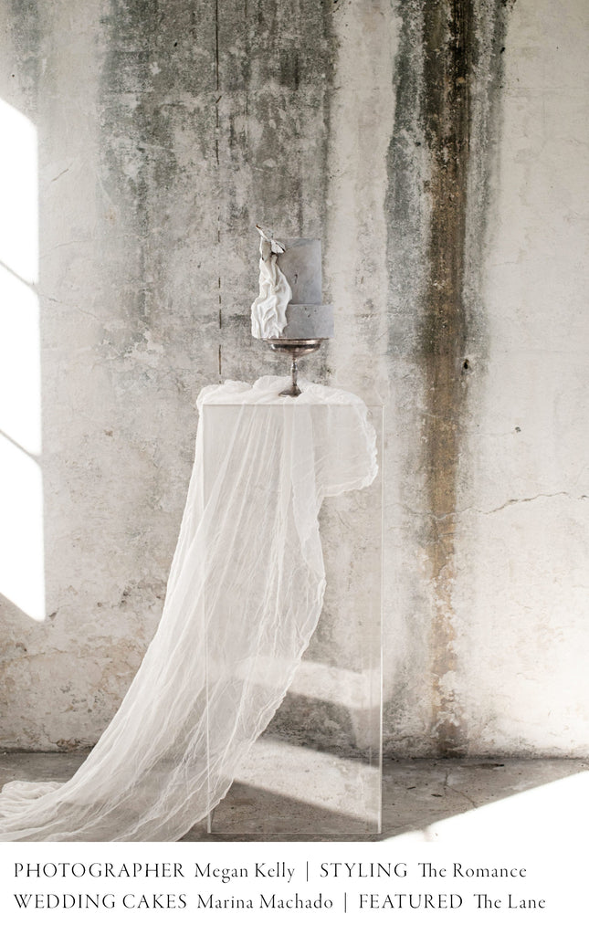 white sheer silk draping from a pedestal display with wedding cake by Marina Machado 