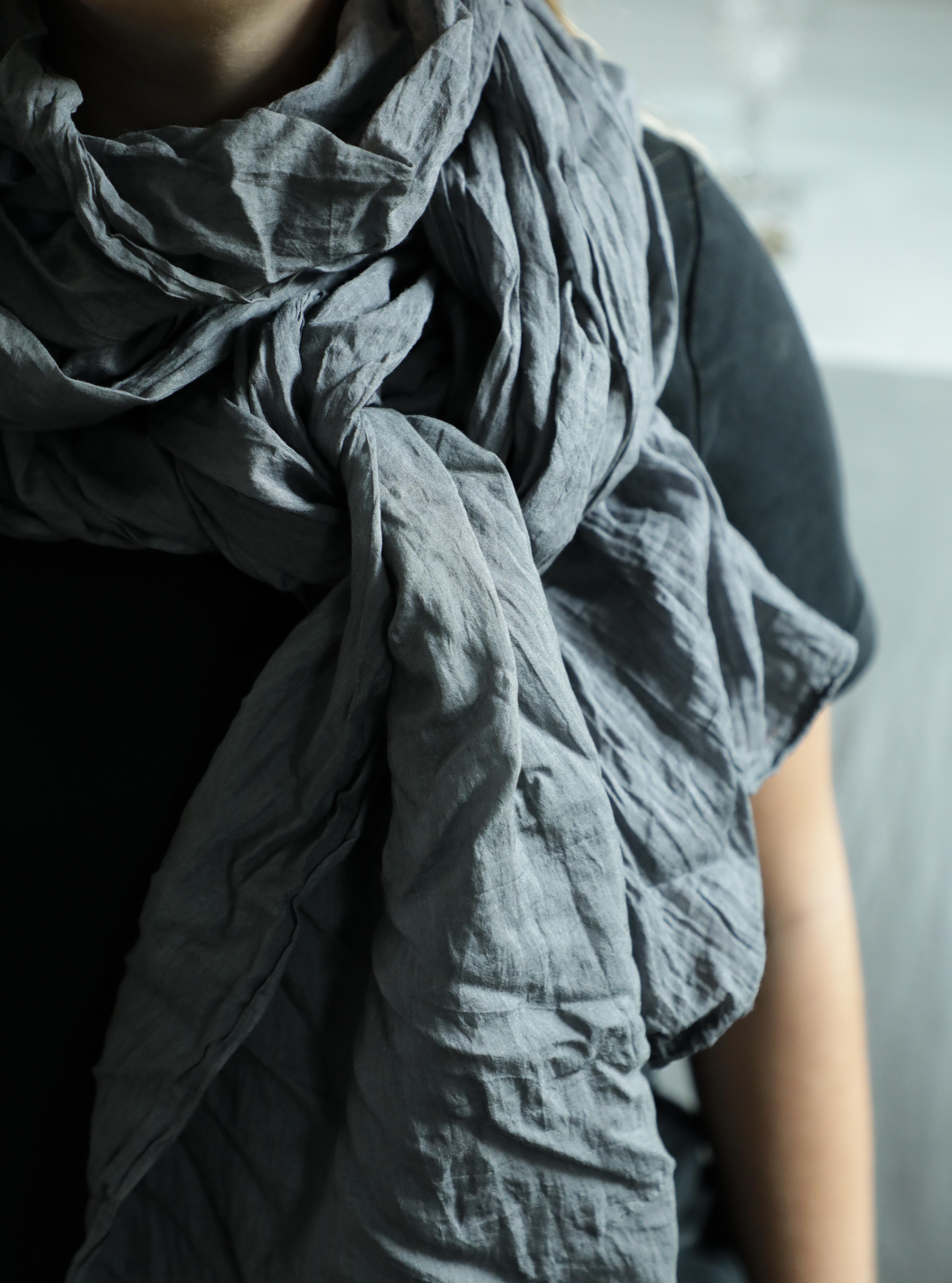 girl wearing a charcoal gray peace silk scarf